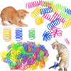 Colorful spring toys for cats with a cat interacting with them on a white background