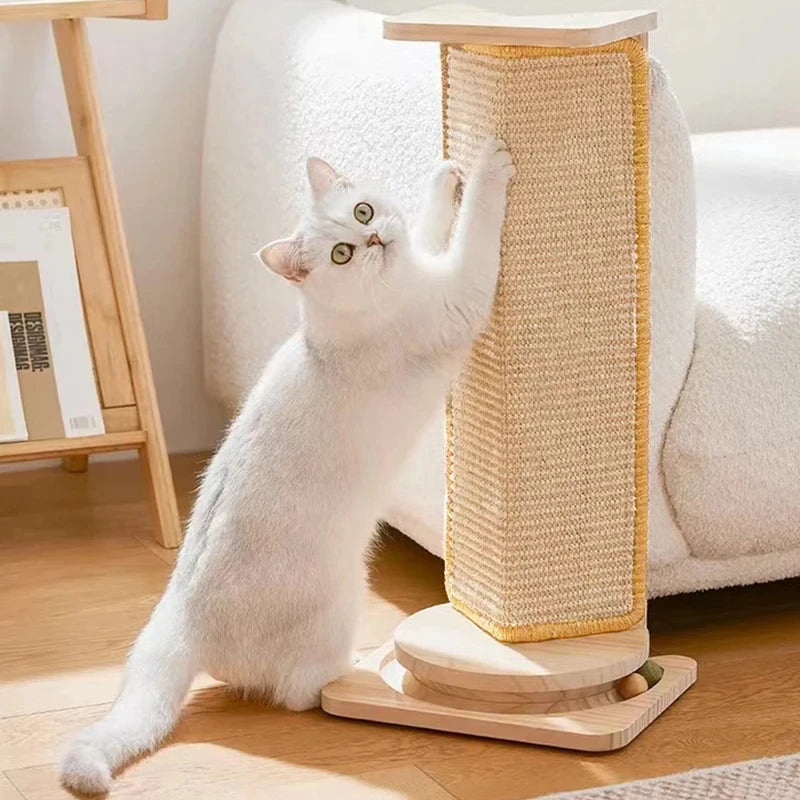 White cat playing with a wooden scratching post on a wooden floor.