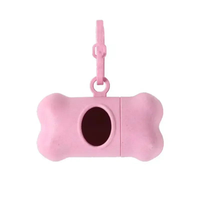 Pink silicone dog toy with bone shape and keychain attachment on a white background
