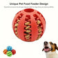 Red pet food feeder ball with dog food inside, accompanied by a dog and other colorful balls on a white background.