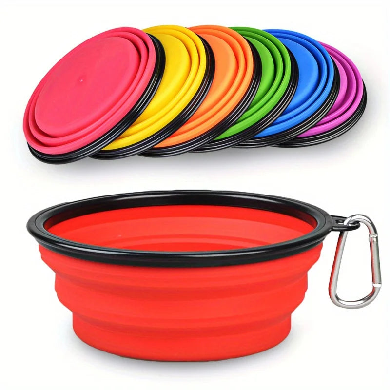 Collapsible silicone dog bowl with carabiner in red, surrounded by colorful lids on a white background