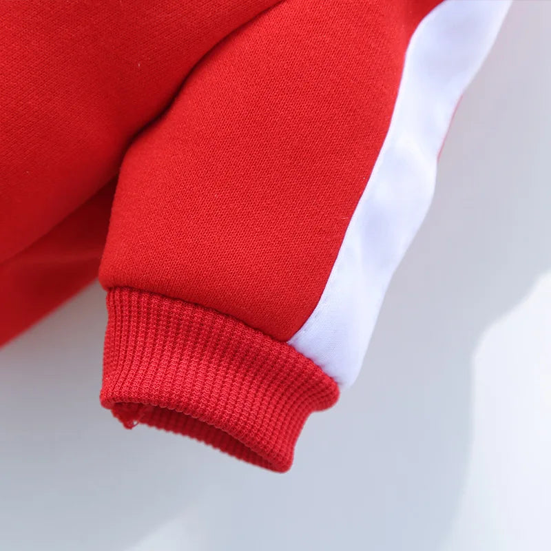 Close-up of a red sleeve with white trim on a light gray background