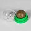 Green container with a clear dome lid and a brown spherical object inside on a white background