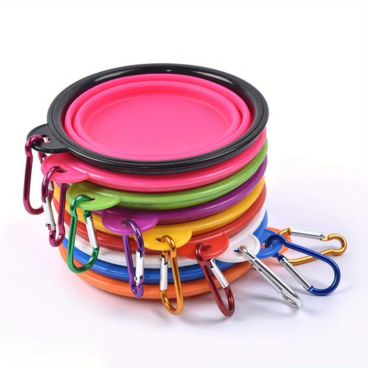 Set of colorful silicone dog bowls with carabiners on a white background