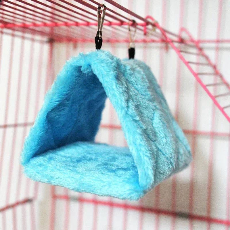 Blue fleece pet hammock hanging inside a cage