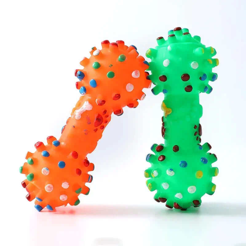 Two colorful dog toys, one orange and one green, on a white background.