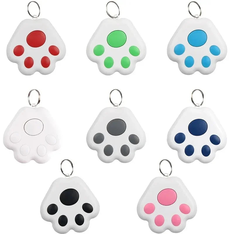 Set of colorful paw-shaped keychains on a white background