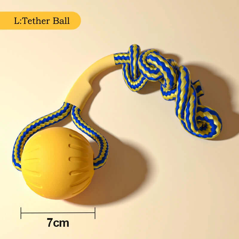 Yellow dog toy with a ball and rope on a beige background