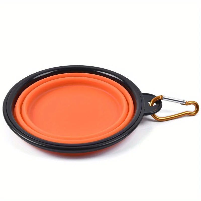 Orange and black collapsible pet bowl with a gold carabiner on a white background