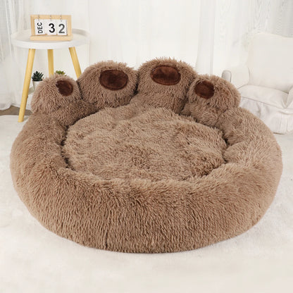 Round fluffy pet bed with bear paw design on a white surface
