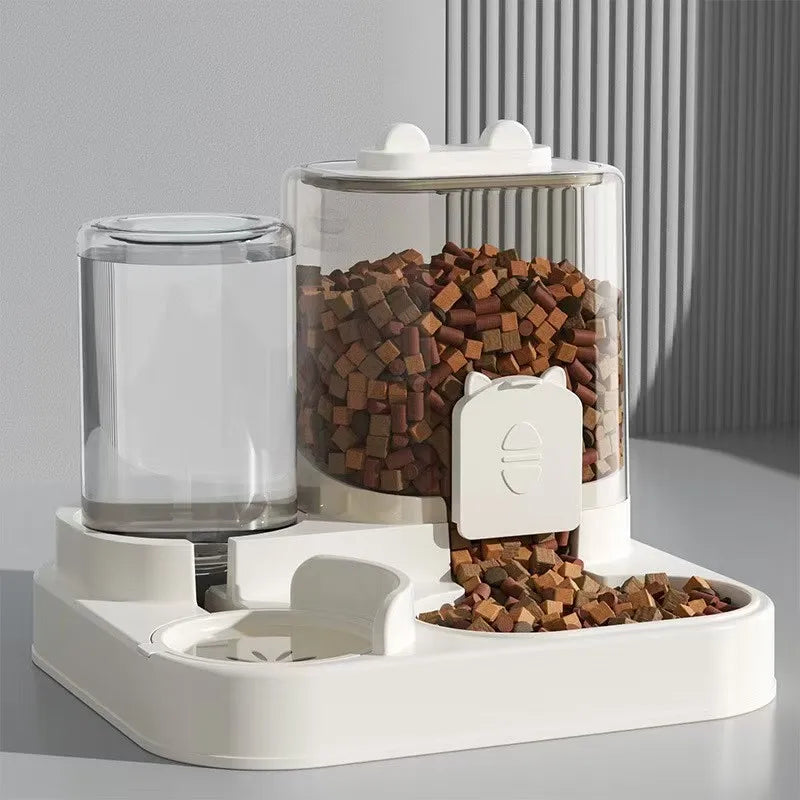 Pet food dispenser with transparent container and pet treats on a gray background