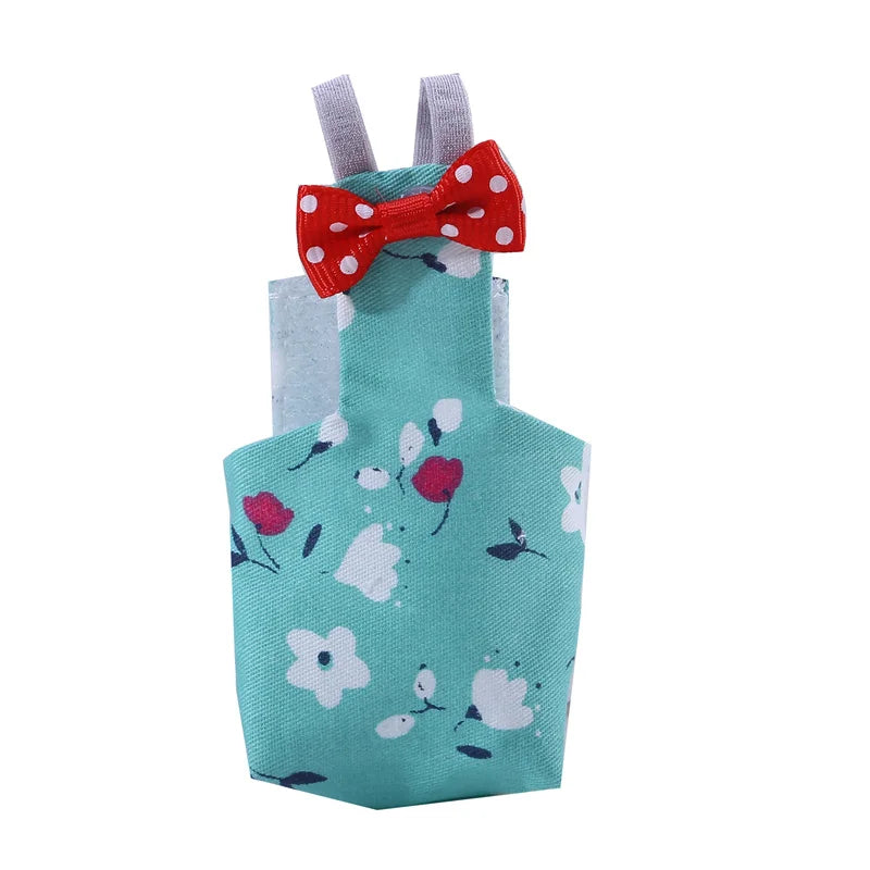 Teal dress with floral pattern and red bow on a white background