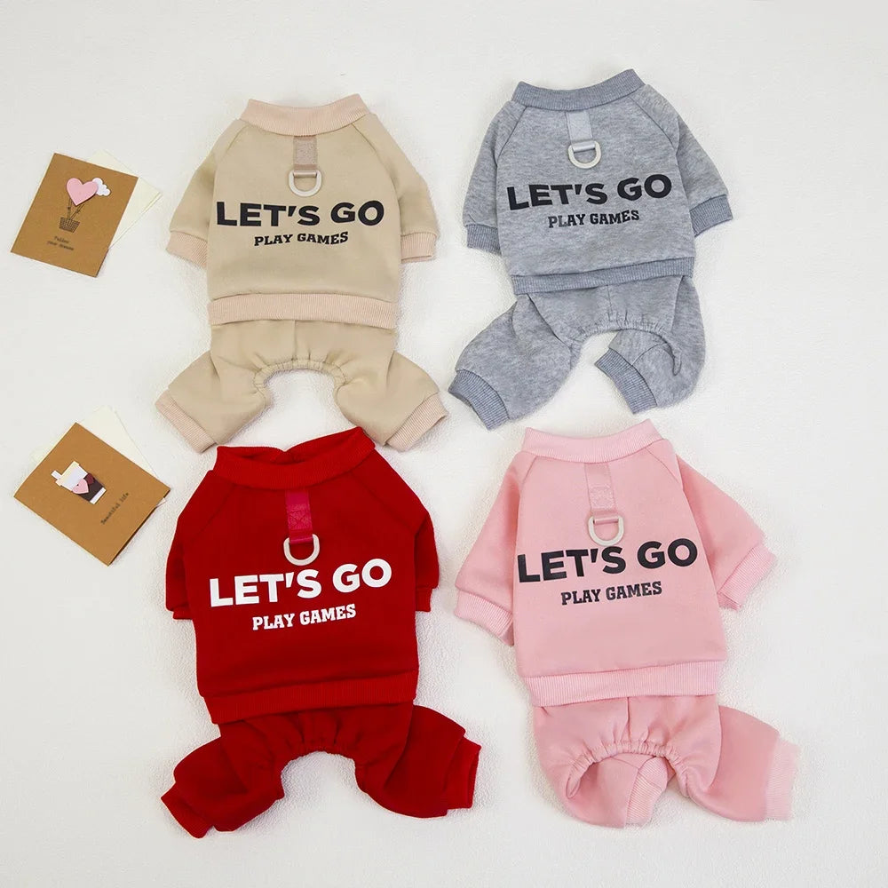 Four dog outfits in beige, gray, red, and pink with 'LET'S GO PLAY GAMES' text on a white background.