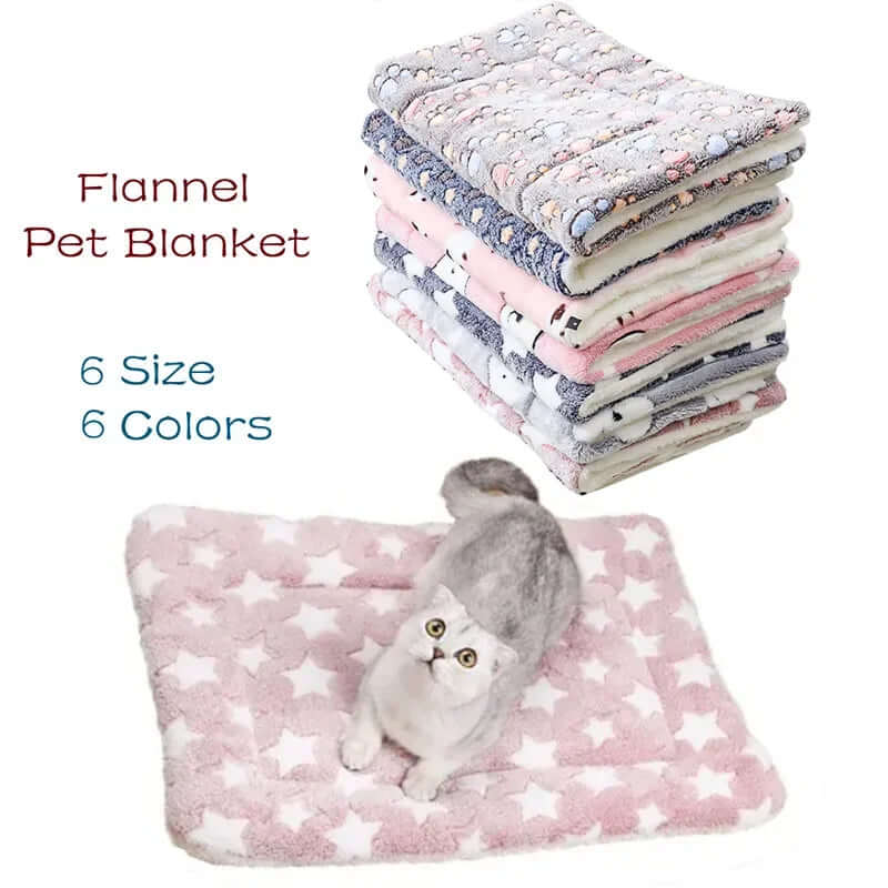 Stack of flannel pet blankets with a cat on a pink star-patterned blanket.