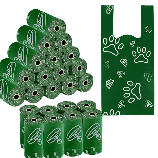 Multiple green rolls of dog waste bags with a towel featuring paw prints on a white background.