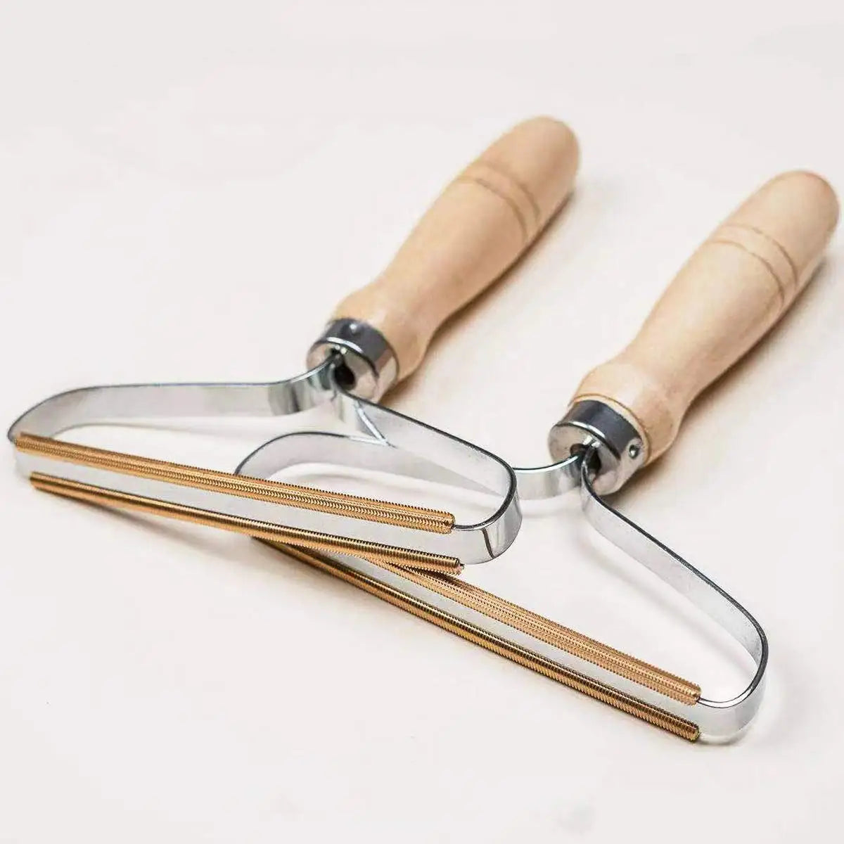 Metal tool with wooden handles on a white background