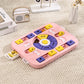 Pink puzzle toy with colorful pieces on a beige carpet