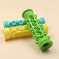 Green, yellow, and blue textured roller toy on a beige background