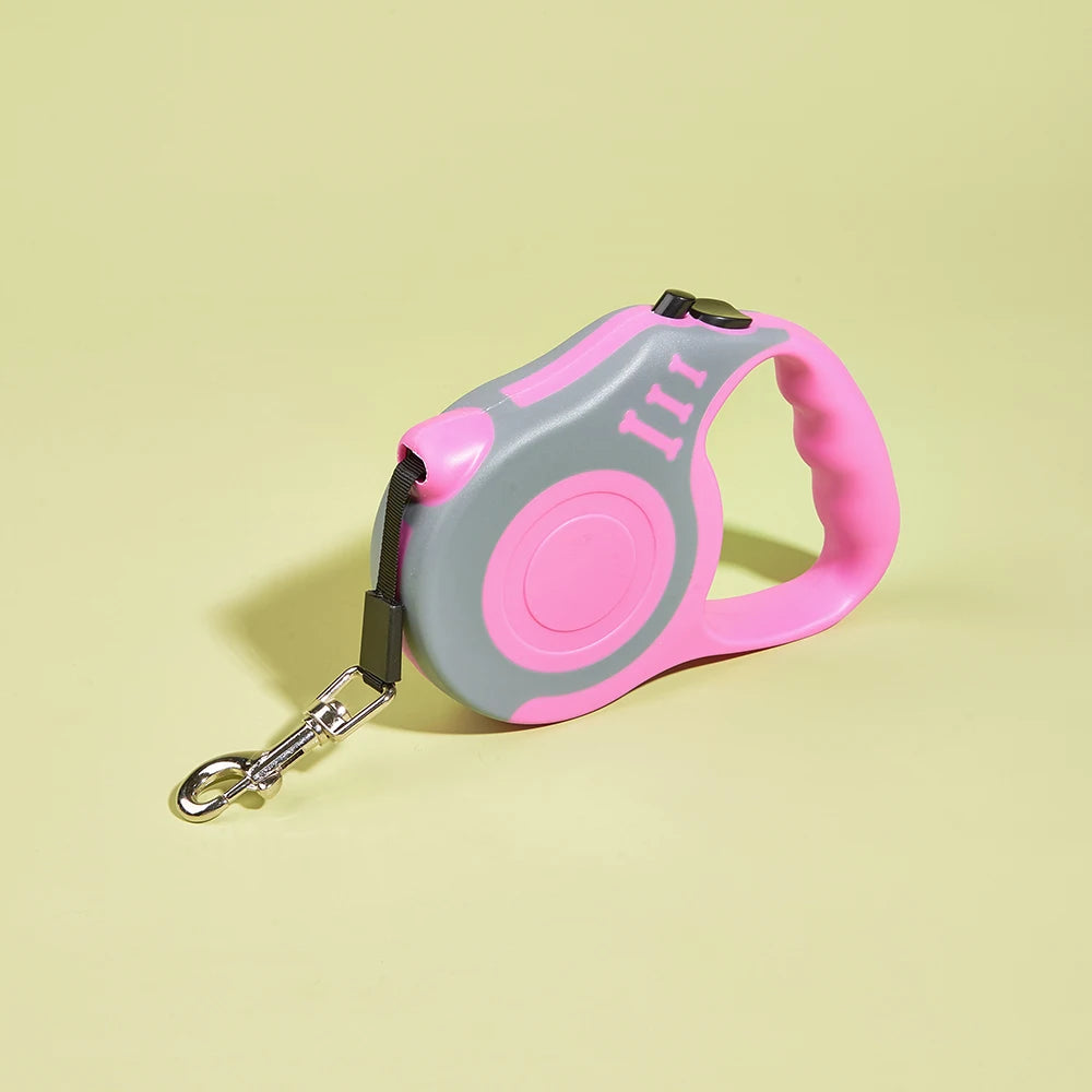 Pink and gray retractable dog leash on a light yellow background