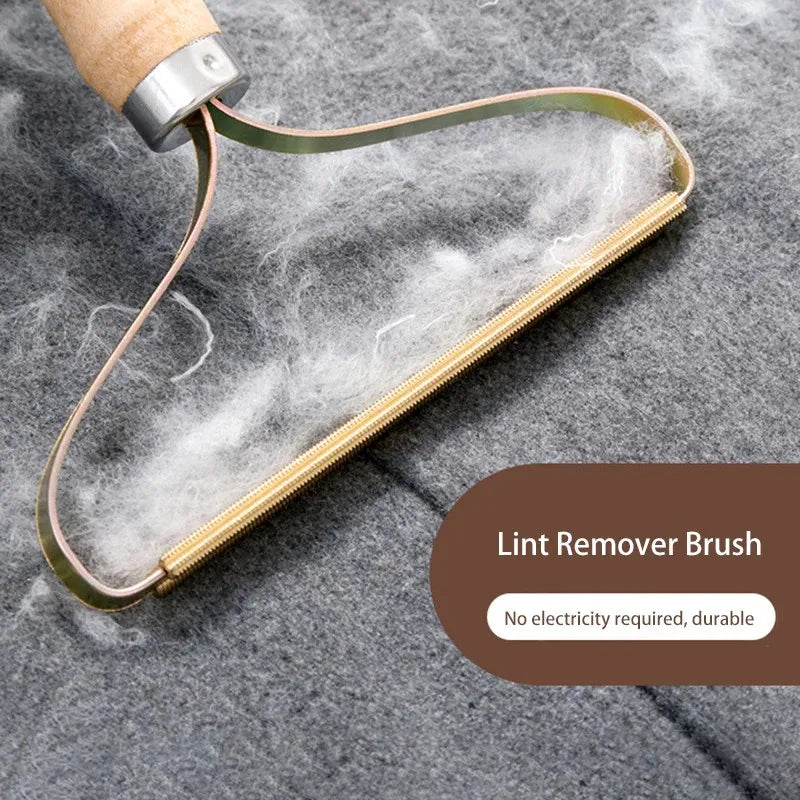 Lint remover brush on a textured surface with text indicating no electricity required and durability.