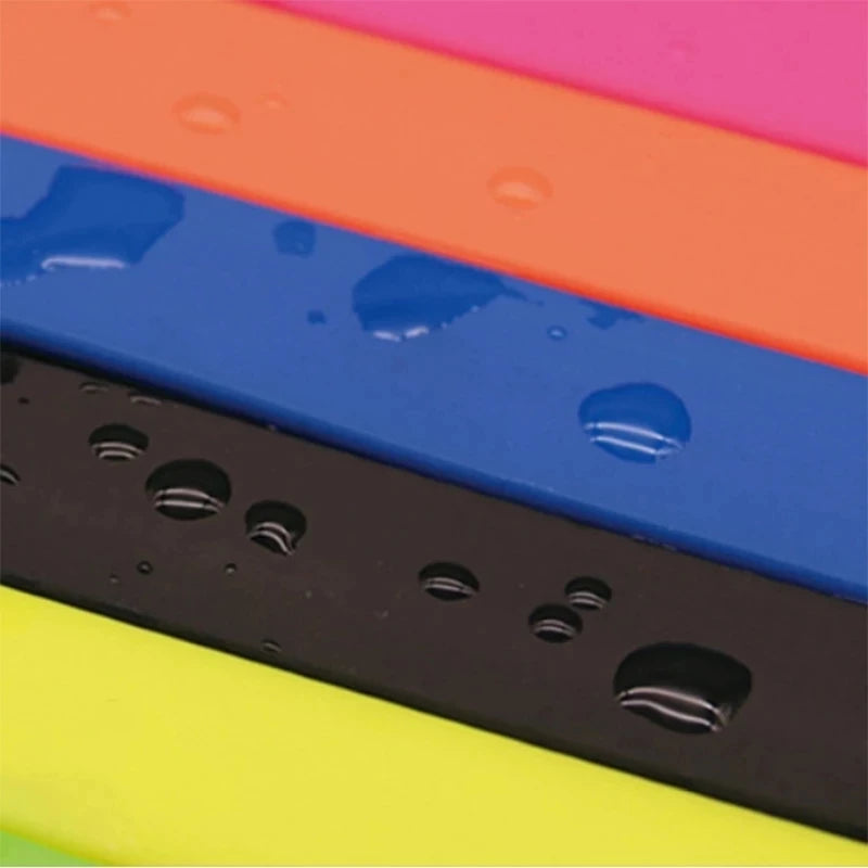 Close-up of colorful phone cases with water droplets on a multicolored background