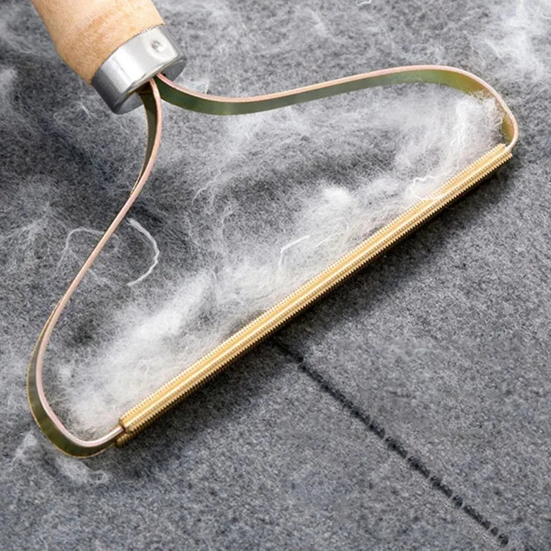 Wooden tool with a metal handle on a textured gray surface
