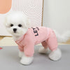 Small white dog wearing a pink outfit with text on a light background