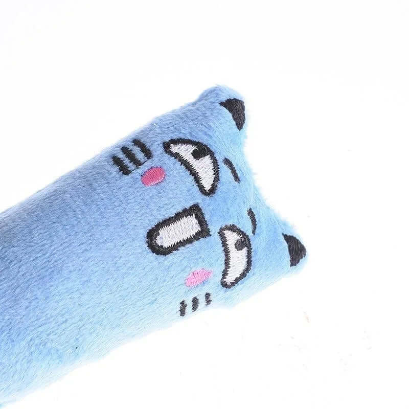 Blue cat-shaped pillow with black whiskers and pink nose on a white background