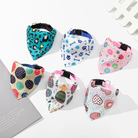 Set of colorful dog bandanas with various patterns on a white surface.