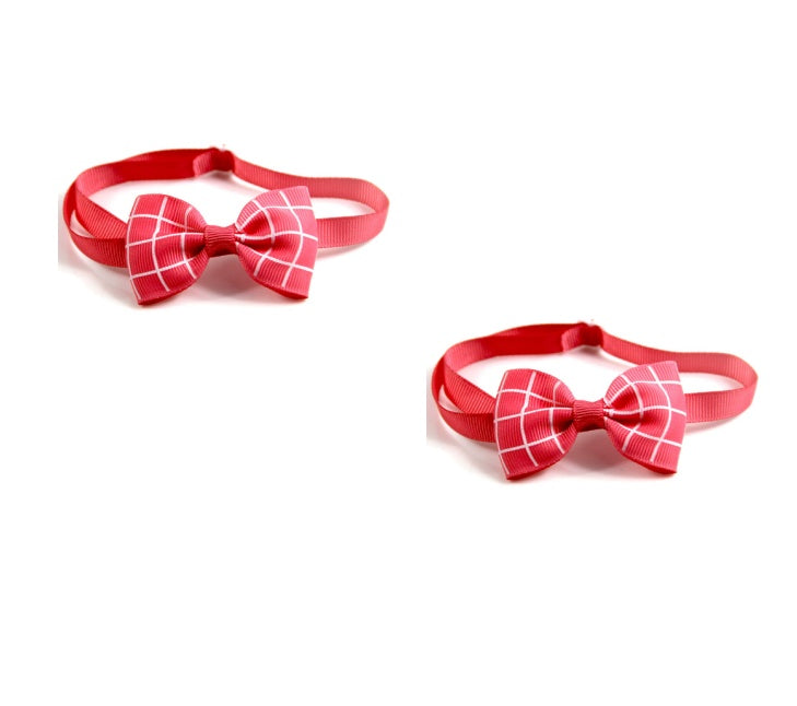 Two red bow ties with plaid patterns on a white background