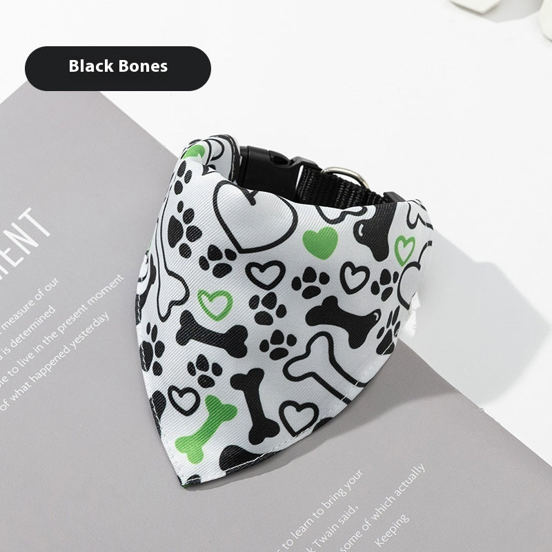 Dog bandana with black bones, green hearts, and paw prints on a white background
